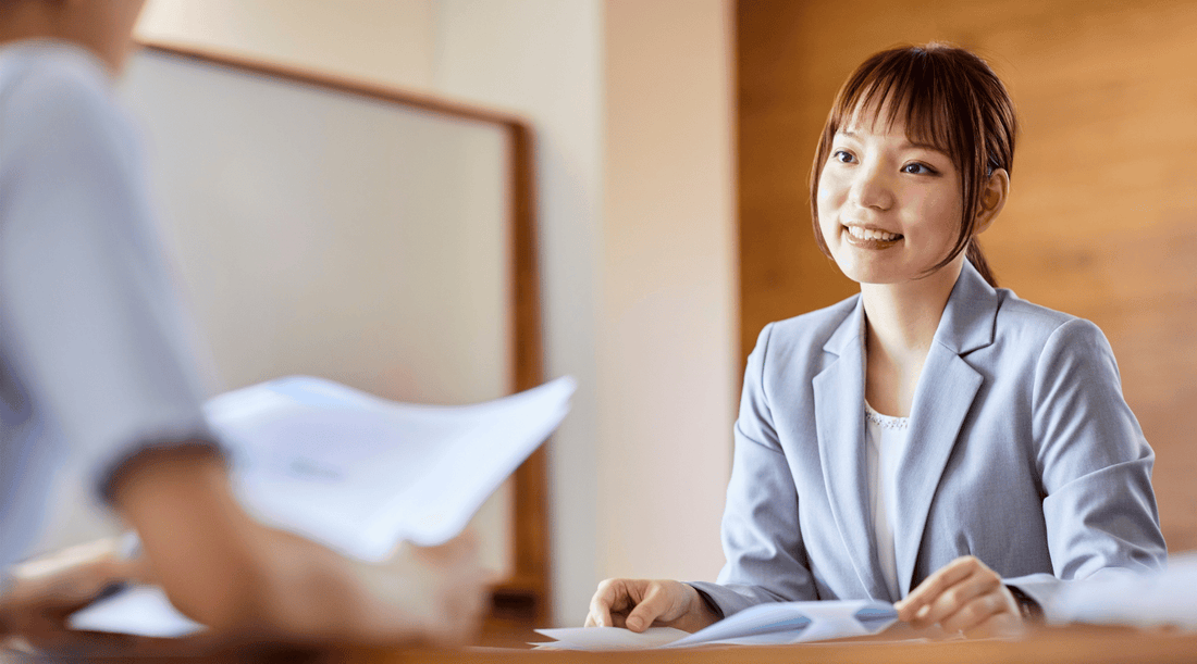 Professional woman in a blazer being interviewed for a job